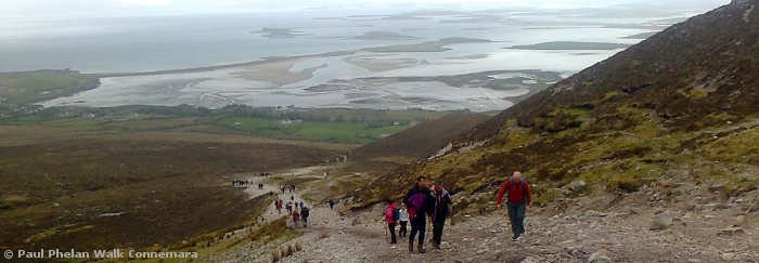 Walkers climbing Croagh Patrick with Clew bay in the distance